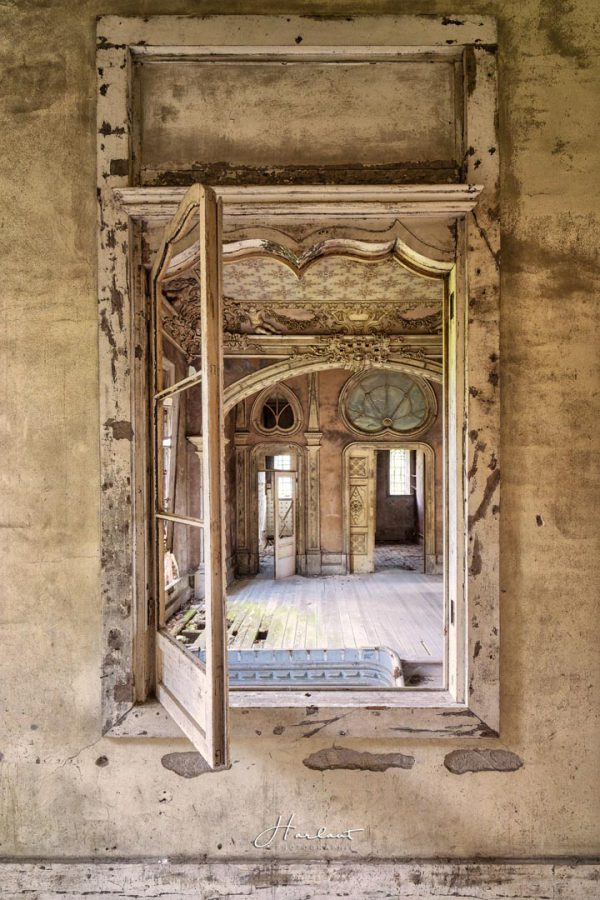 Photographie d'une chambre prise depuis une fenêtre intérieure. 