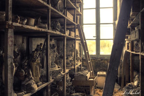 Photographie de statuettes entreposées sur des étagères.